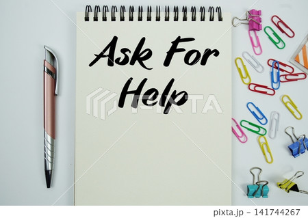 Ask For Help text message written on notepad with stationery flat lay on white background 141744267
