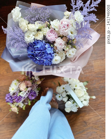 Top view of elegant pastel flower bouquets on wooden floor with soft natural light Top view of elegant pastel flower bouquets on wooden floor with soft natural light 141746008