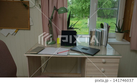 Remote workplace of accountant, bookkeeper. No people. Work place in a kitchen. Working from home. Business report, data entry for company tasks. Laptop, calculator and paperwork. Study, productivity 141746037