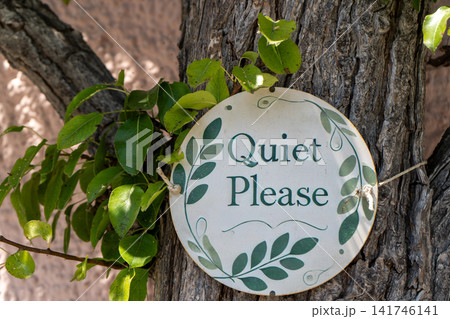 Sign with a Message Quiet Please Hanging on a Tree Trunk in a Garden Sign with a Message Quiet Please Hanging on a Tree Trunk in a Garden 141746141