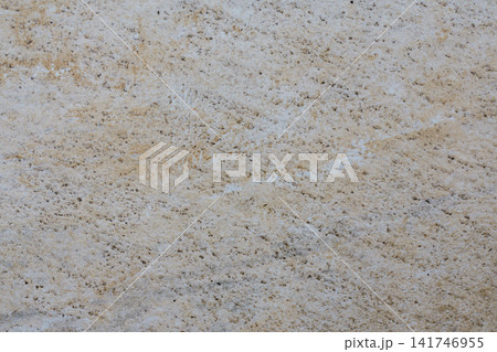Aged beige wall surface with small irregularities, weathering marks and a natural abstract pattern. 141746955