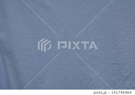 Solid blue fabric close up with fine textile texture, soft folds and small natural surface irregularities. Solid blue fabric close up with fine textile texture, soft folds and small natural surface irregularities. 141746964