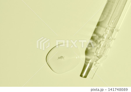 Cosmetic transparent product on a yellow background. A serum or gel or cream. 141748089