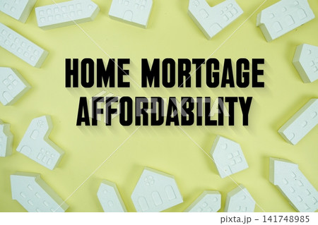 Home Mortgage Affordability text with house models on yellow background Home Mortgage Affordability text with house models on yellow background 141748985