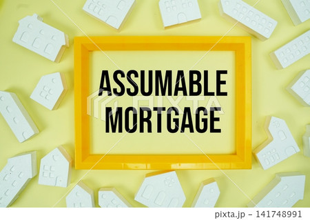 Assumable Mortgage text with house models on yellow background 141748991