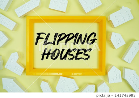 Flipping Houses text with house models on yellow background Flipping Houses text with house models on yellow background 141748995