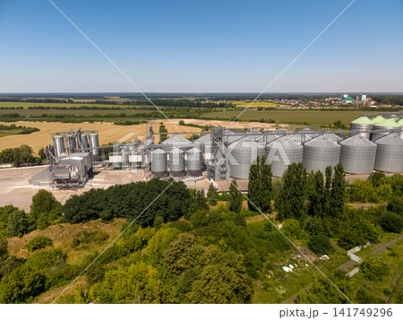 Panoramic Drone View of Industrial Silo Storage Infrastructure and Distant Town Panoramic Drone View of Industrial Silo Storage Infrastructure and Distant Town 141749296
