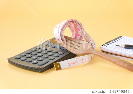 A white measuring tape rap around fork,Health care. A white measuring tape rap around fork,Health care. 141749845