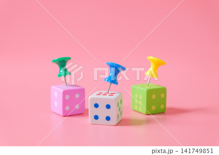 Push pin on dice game on color background. Push pin on dice game on color background. 141749851
