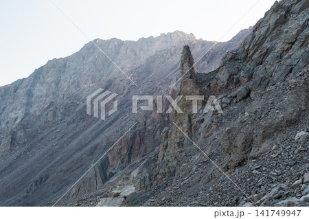 Sinai mountains in Dahab, Egypt feature rugged terrain with steep rocky slopes and a prominent rock formation. The landscape showcases natural beauty and geological diversity. Sinai mountains in Dahab, Egypt feature rugged terrain with steep rocky slopes and a prominent rock formation. The landscape showcases natural beauty and geological diversity. 141749947