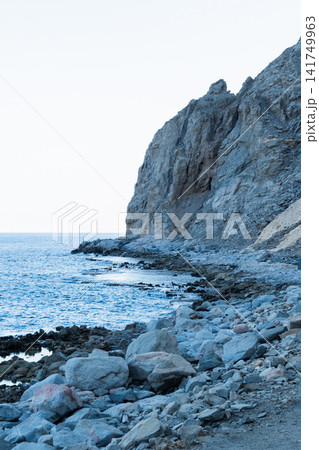 Natural pools along the Red Sea coast in Dahab, Egypt. Rocky shoreline under the Sinai mountains with clear blue water. 141749963