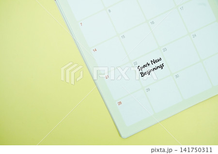 Spark New Beginnings message written on calendar date flat lay on yellow background 141750311