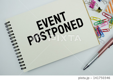Event Postponed text message written on notepad with stationery flat lay on white background Event Postponed text message written on notepad with stationery flat lay on white background 141750346
