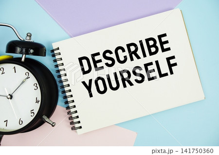 Describe Yourself text written on notepad with alarm clock flat lay on multicolor pastel background Describe Yourself text written on notepad with alarm clock flat lay on multicolor pastel background 141750360