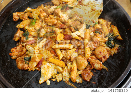 Spicy Korean Chicken Stir Fry Dakgalbi with Vegetables on Iron Pan 141750530