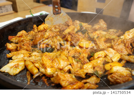 Spicy Korean Chicken Stir Fry Dakgalbi with Vegetables on Iron Pan Spicy Korean Chicken Stir Fry Dakgalbi with Vegetables on Iron Pan 141750534
