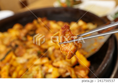 Spicy Korean Chicken Stir Fry Dakgalbi with Vegetables on Iron Pan Spicy Korean Chicken Stir Fry Dakgalbi with Vegetables on Iron Pan 141750537