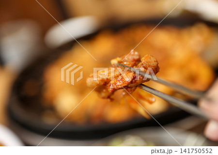 Spicy Korean Chicken Stir Fry Dakgalbi with Vegetables on Iron Pan Spicy Korean Chicken Stir Fry Dakgalbi with Vegetables on Iron Pan 141750552