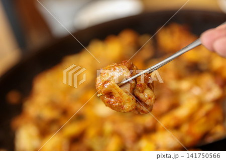 Spicy Korean Chicken Stir Fry Dakgalbi with Vegetables on Iron Pan Spicy Korean Chicken Stir Fry Dakgalbi with Vegetables on Iron Pan 141750566