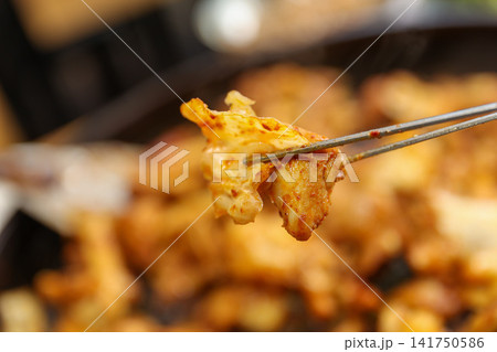 Spicy Korean Chicken Stir Fry Dakgalbi with Vegetables on Iron Pan Spicy Korean Chicken Stir Fry Dakgalbi with Vegetables on Iron Pan 141750586