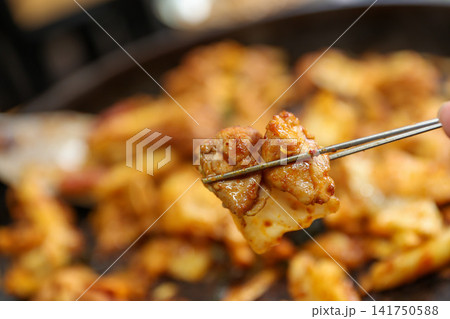 Spicy Korean Chicken Stir Fry Dakgalbi with Vegetables on Iron Pan Spicy Korean Chicken Stir Fry Dakgalbi with Vegetables on Iron Pan 141750588