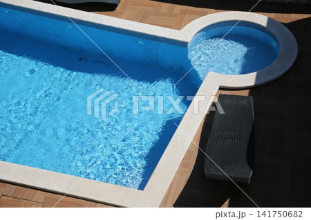 Modern swimming pool edge with sun loungers. Modern swimming pool edge with sun loungers. 141750682