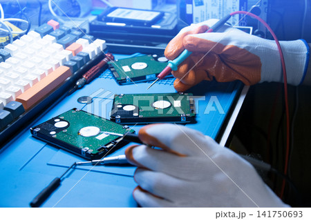 A technician about to repair a hard drive, a computer component. 141750693
