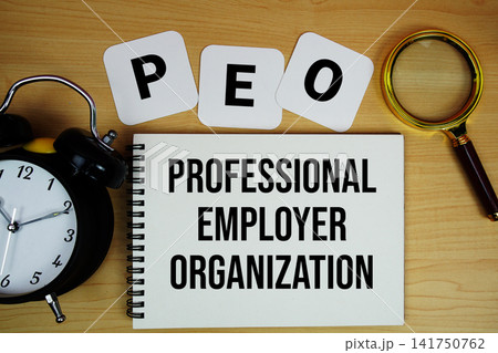 PEO Professional Employer Organization text written on notepad with magnifying glass and alarm clock on wooden background PEO Professional Employer Organization text written on notepad with magnifying glass and alarm clock on wooden background 141750762
