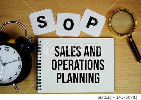 S and OP Sales And Operations Planning text written on notepad with magnifying glass and alarm clock on wooden background S and OP Sales And Operations Planning text written on notepad with magnifying glass and alarm clock on wooden background 141750783