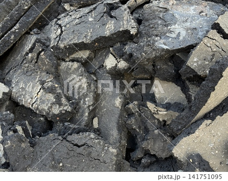 Cracked asphalt pieces creating textured urban background with rugged surface details Cracked asphalt pieces creating textured urban background with rugged surface details 141751095