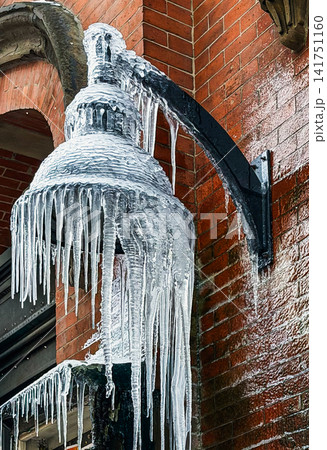 Street Lantern Covered in Thick Icicles and Ice After Freezing Rain Storm Street Lantern Covered in Thick Icicles and Ice After Freezing Rain Storm 141751160