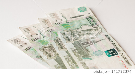Four one thousand Russian Ruble banknotes fanned out on a white surface Four one thousand Russian Ruble banknotes fanned out on a white surface 141752374