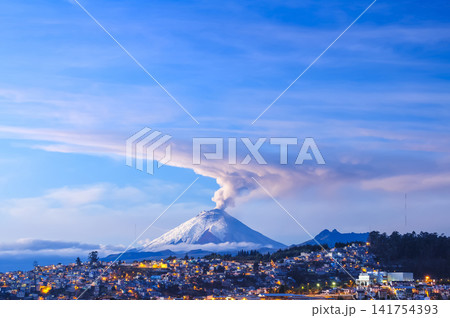 Cotopaxi volcano, active and emitting a column of gas and steam, seen at dawn from Quito, Ecuador. Cotopaxi volcano, active and emitting a column of gas and steam, seen at dawn from Quito, Ecuador. 141754393