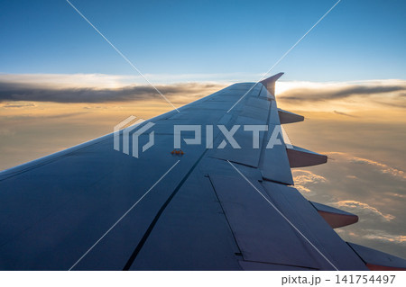 Beautiful window view while traveling by an airplane during sunset. Beautiful window view while traveling by an airplane during sunset. 141754497