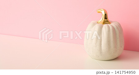 Halloween. Decorative white pumpkin with golden details stands on a table 141754950