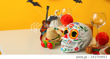 Halloween. Table filled with Halloween decorations, including skull and pumpkin Halloween. Table filled with Halloween decorations, including skull and pumpkin 141754951