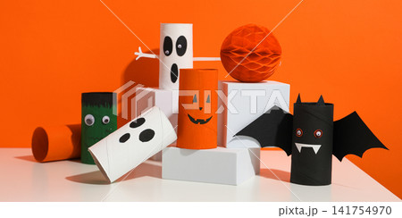 Halloween background. Children create Halloween decorations using various materials for celebration Halloween background. Children create Halloween decorations using various materials for celebration 141754970