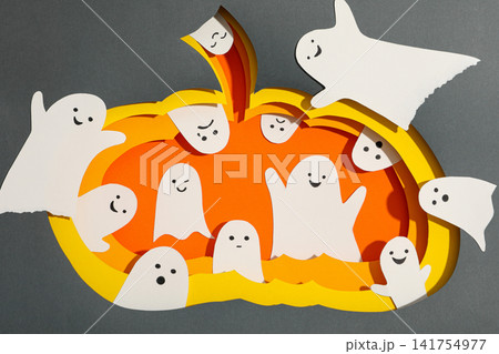 Halloween. Playful paper ghosts surround a vibrant jack o lantern design Halloween. Playful paper ghosts surround a vibrant jack o lantern design 141754977