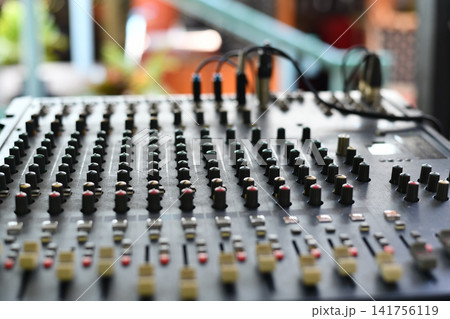 Audio mixer, sound console, knob, cable on blurred studio background Audio mixer, sound console, knob, cable on blurred studio background 141756119