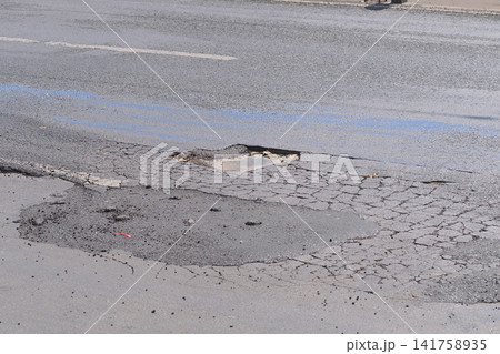 Pothole on city road after heavy rain Pothole on city road after heavy rain 141758935