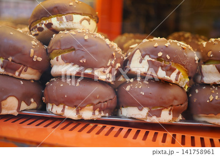Baked goods on display in a shop window Baked goods on display in a shop window 141758961