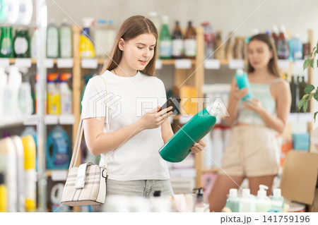 Young woman scanning qr code for detergent 141759196
