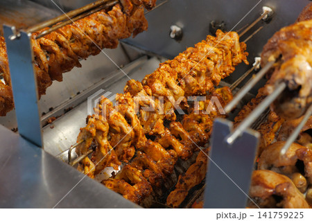 Grilling chicken skewers at a street food stall 141759225