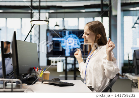 Overjoyed tech startup intern dancing on office desk chair, pleased after managing to streamline workflows with AI. Ecstatic female computer scientist celebrating implementing artificial intelligence Overjoyed tech startup intern dancing on office desk chair, pleased after managing to streamline workflows with AI. Ecstatic female computer scientist celebrating implementing artificial intelligence 141759232