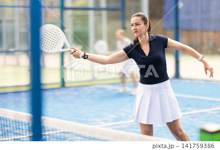 woman participates in a paddle tennis tournament 141759386