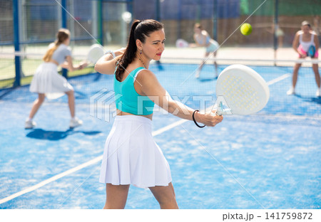 Young woman in sportswear playing paddle 141759872
