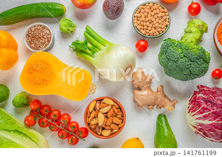 Healthy plant based food background with vegetables, legumes, nuts and seeds, top view with copy space Healthy plant based food background with vegetables, legumes, nuts and seeds, top view with copy space 141761199