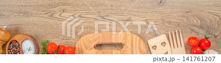 Rustic kitchen utensils and fresh ingredients on wooden table background with copy space, top view banner Rustic kitchen utensils and fresh ingredients on wooden table background with copy space, top view banner 141761207