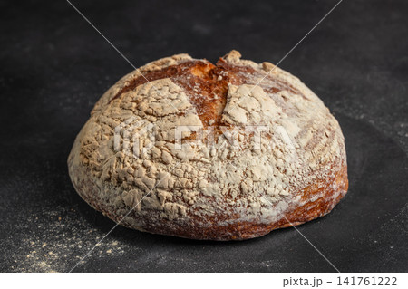 Rustic artisan sourdough bread loaf on dark background close up Rustic artisan sourdough bread loaf on dark background close up 141761222