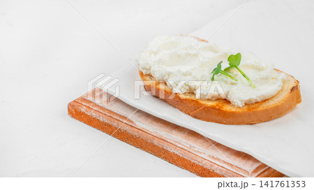 Cream cheese toast with microgreens on white background and copy space Cream cheese toast with microgreens on white background and copy space 141761353